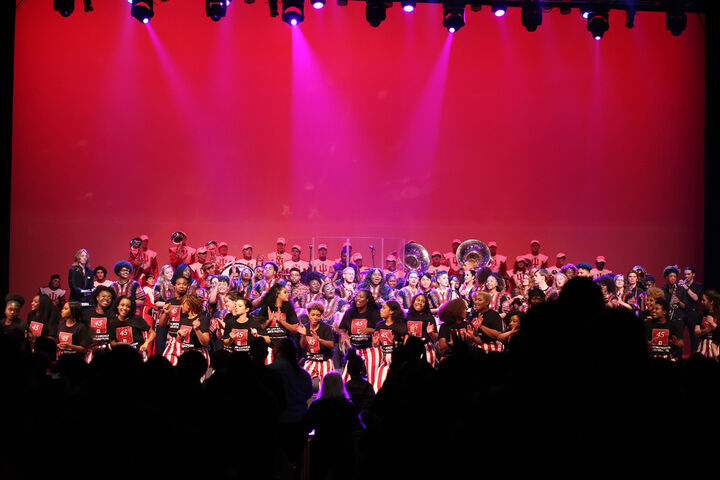 Members of the African American Arts Institute perform on stage.